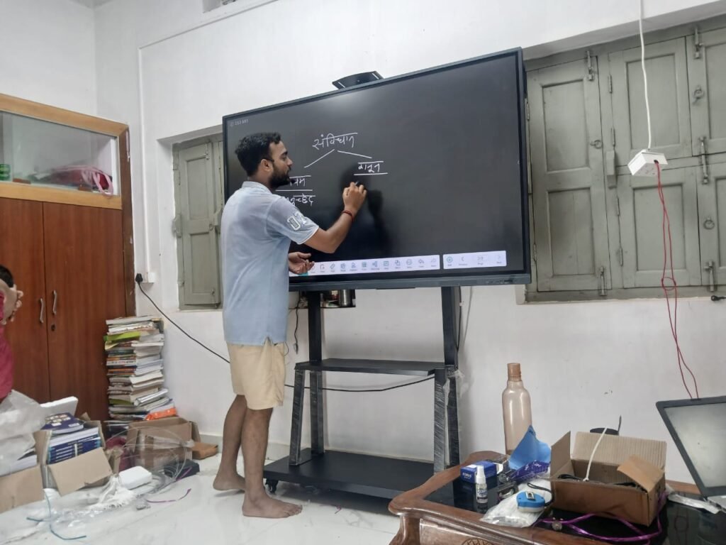 Pan India smart classroom solutions with digital boards and displays" alt="Teacher using interactive digital smart board in a modern classroom